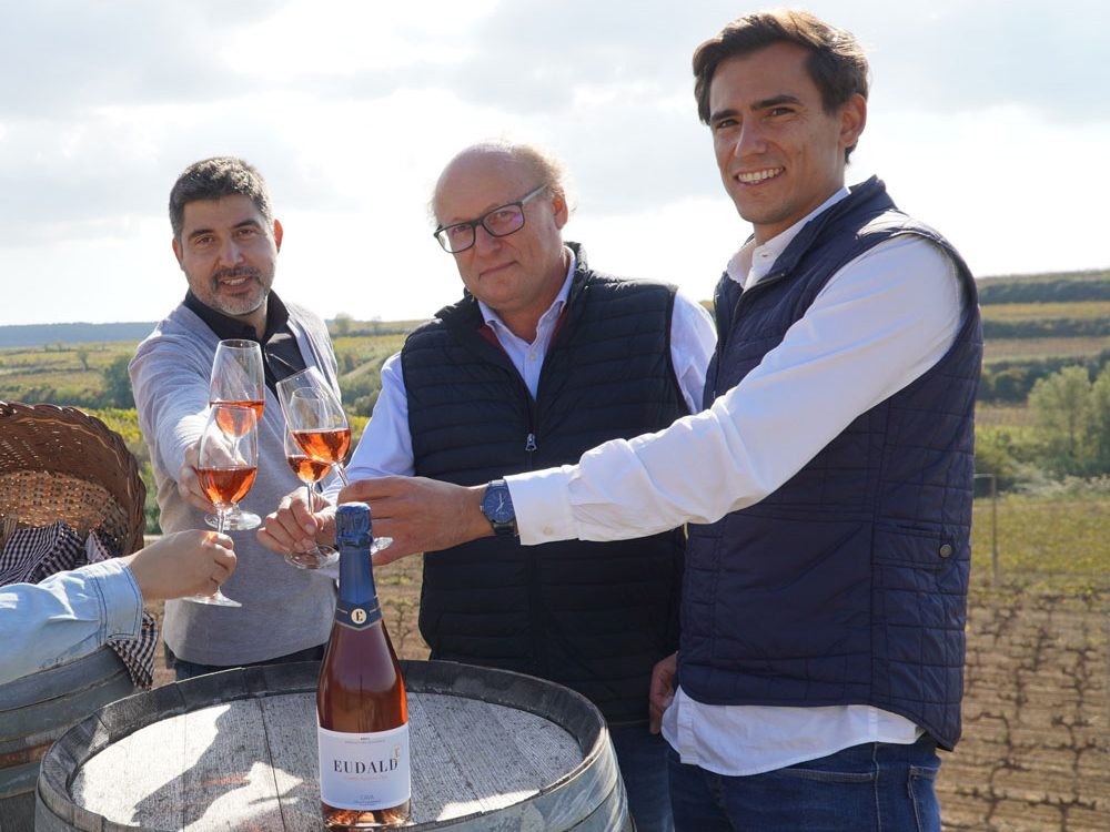 Eduald i Oriol Massana tastant un cava a les vinyes.